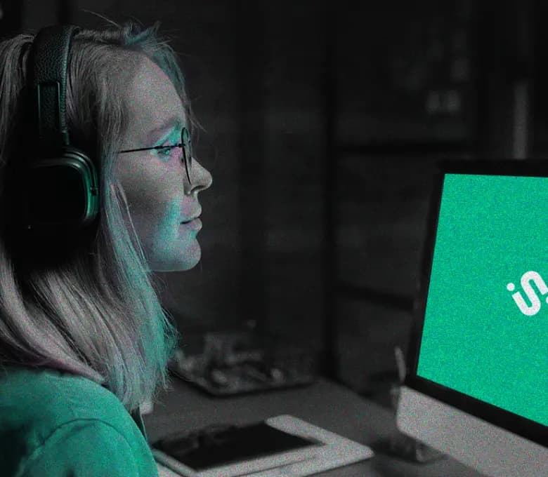 Young person with glasses working on the computer.